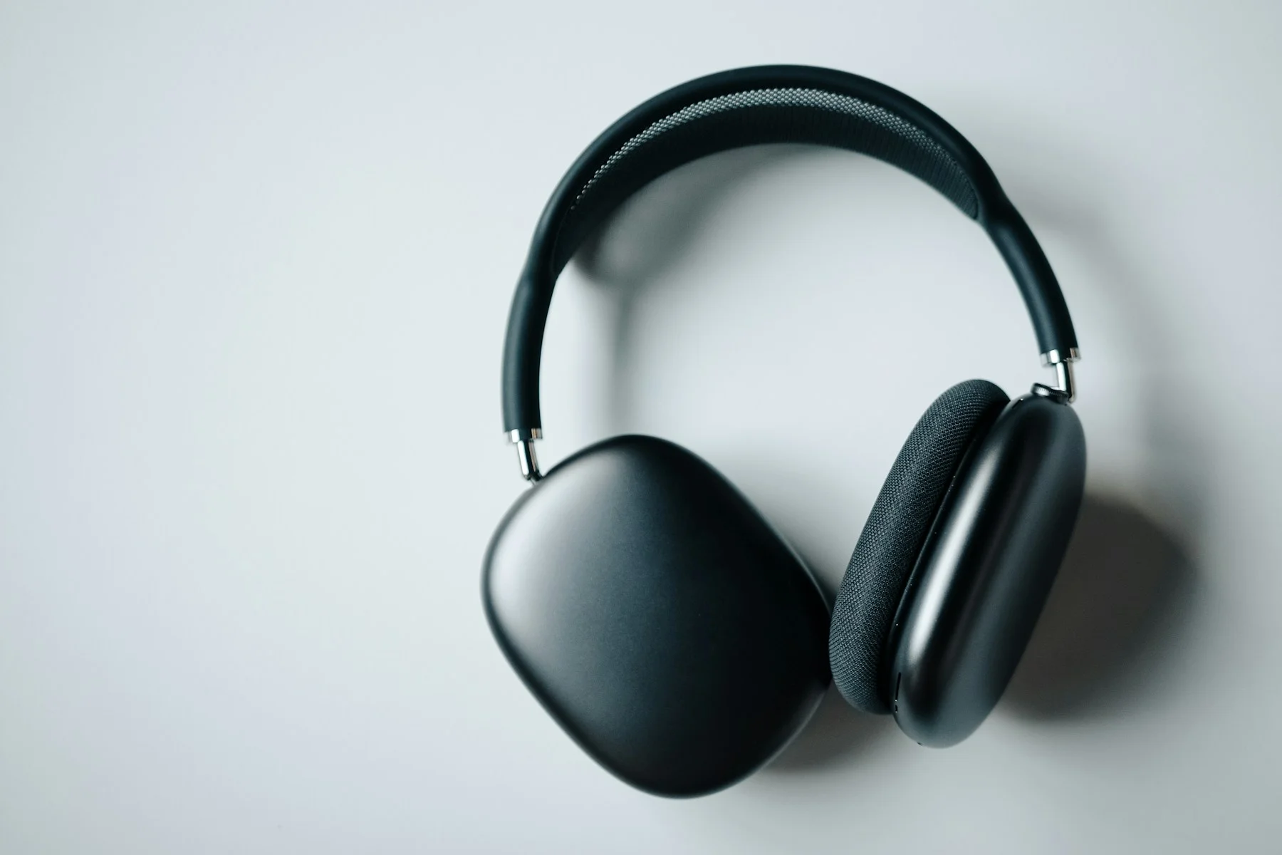 Black over-ear headphones on a pale surface