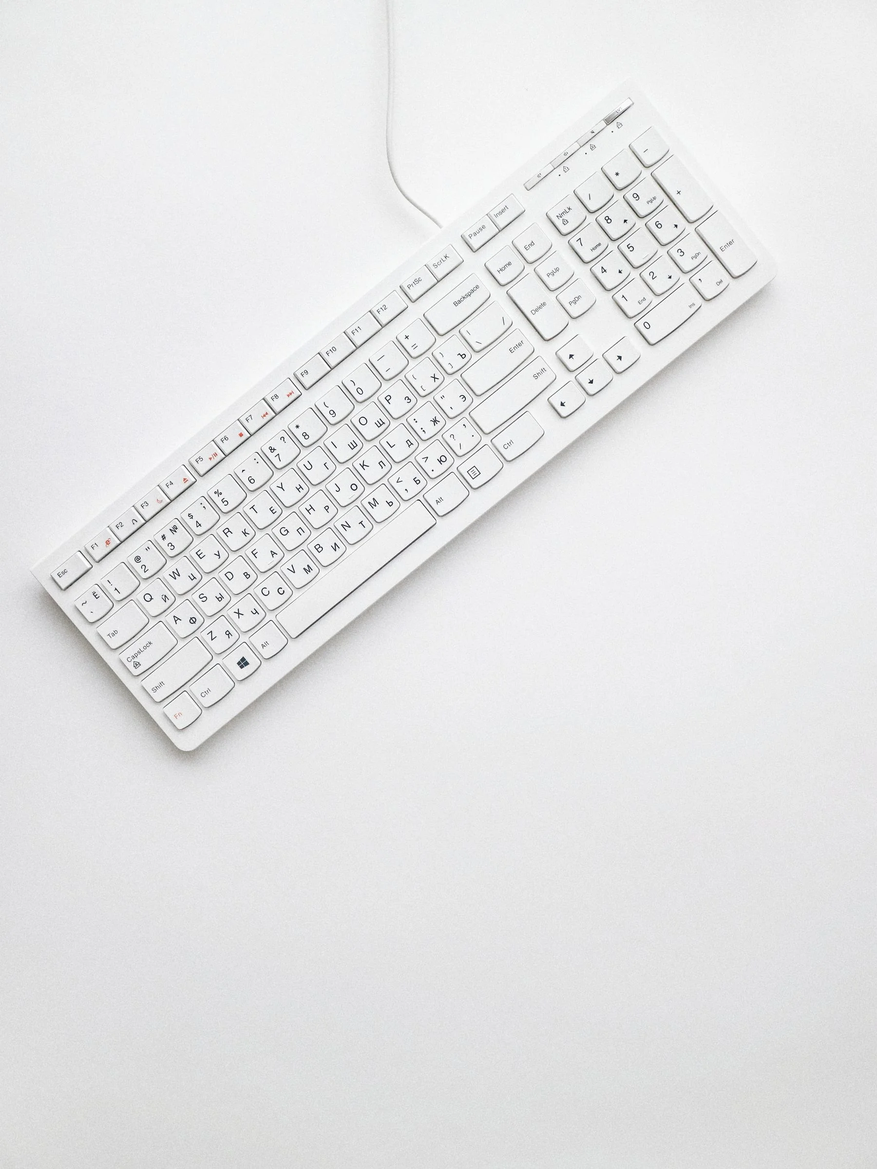 A white compact keyboard photographed from above