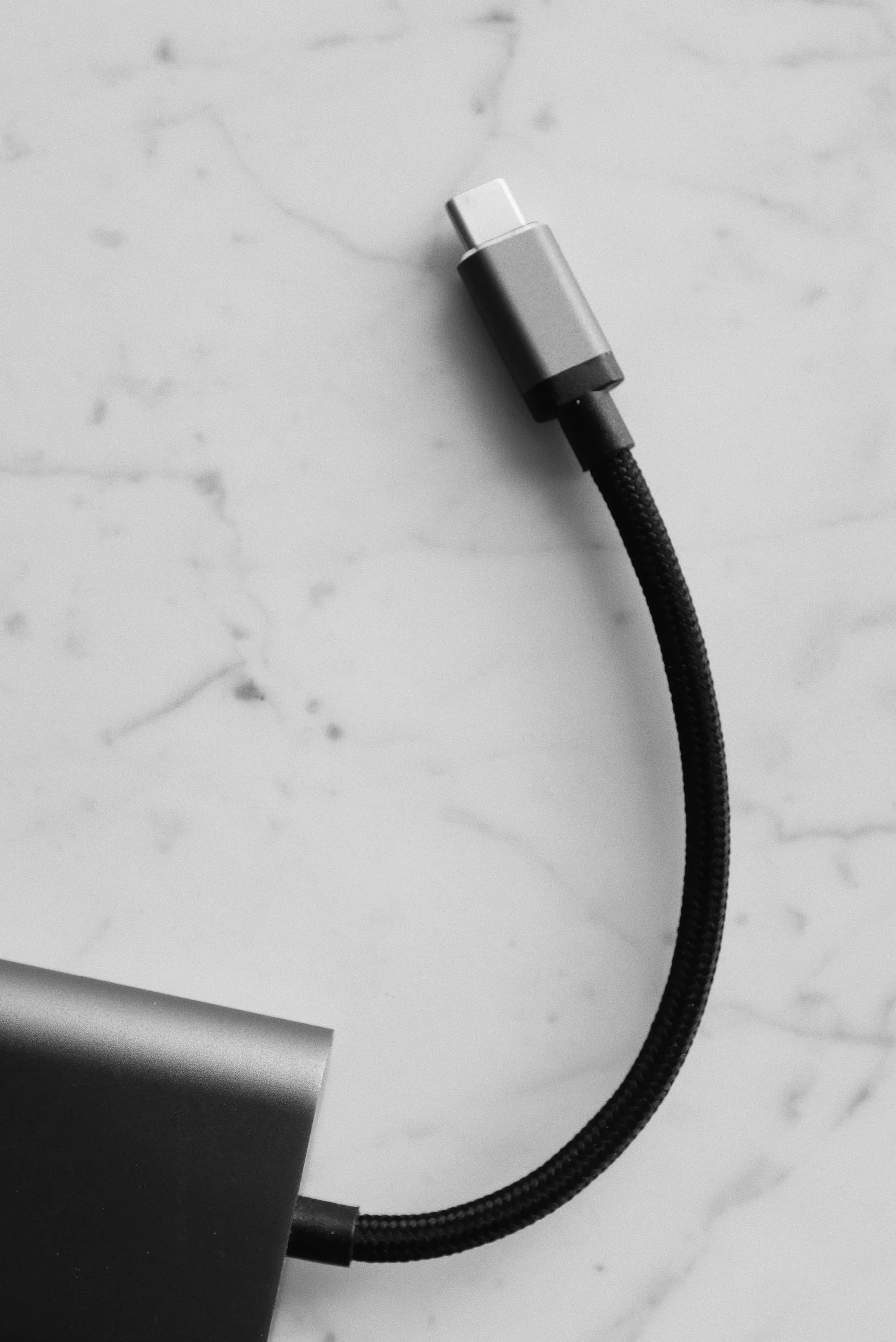 Close-up of a USB-C cable on a pale marble surface